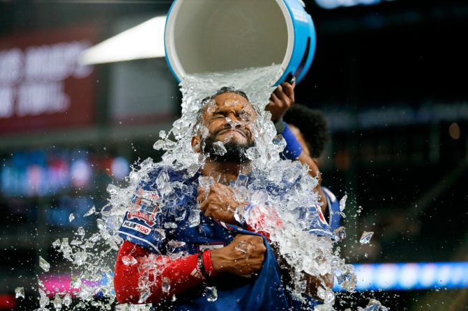 Texas Rangers' Delino DeShields receives an ice water shower from Elvis Andrus after hitting a game-winning RBI single in the 12th inning of the team's baseball game against the Baltimore Orioles, Wednesday, June 5, 2019, in Arlington, Texas. Texas won 2-1. 