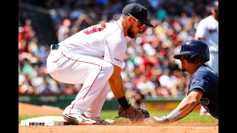 Willy Adames #1 of the Tampa Bay Rays is tagged out at first base by Michael Chavis #23 of the Boston Red Sox in the fourth inning during game one of a double header at Fenway Park on June 8, 2019 in Boston.
