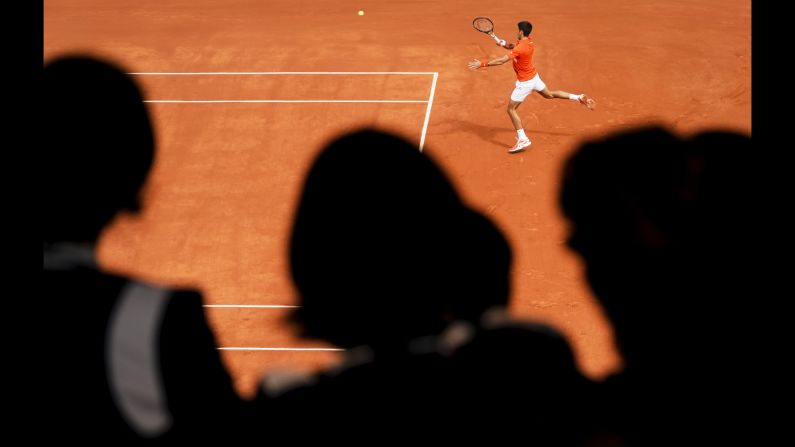 Serbia's Novak Djokovic returns the ball to Austria's Dominic Thiem during their men's singles semi-final match on day 13 of the Roland Garros 2019 French Open tennis tournament in Paris on June 7, 2019.