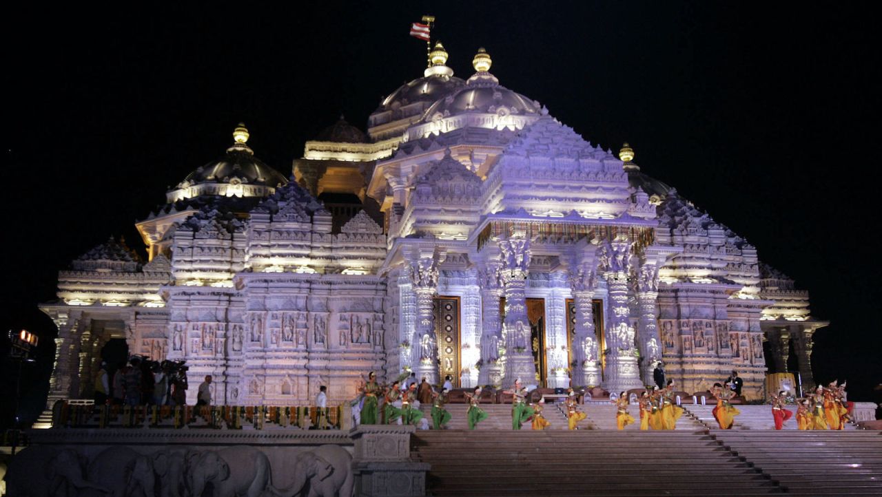 Indian dancers perform a routine in front of New Delhi's Swaminarayan Akshardham Temple during its inauguration ceremony in 2005.   