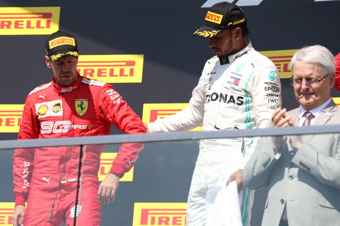Sebastian Vettel reluctantly made his way to the podium after the stewards' decision.