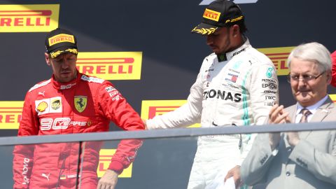 Sebastian Vettel reluctantly made his way to the podium after the stewards' decision at the Canadian GP.
