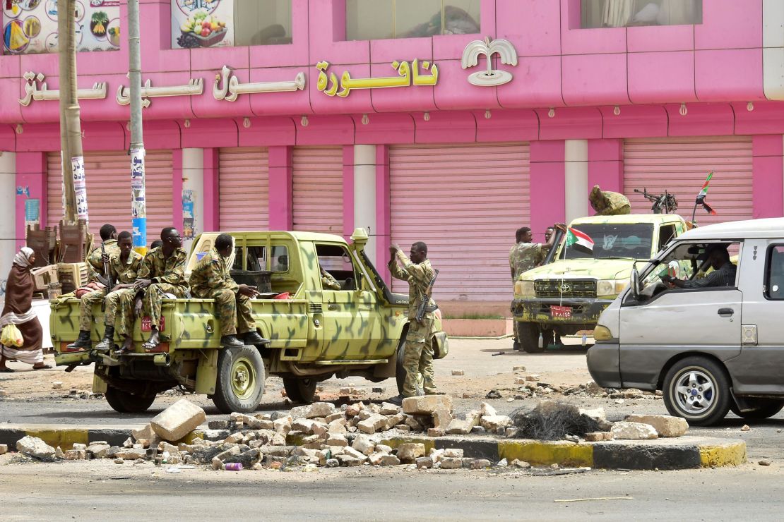 Sudanese soldiers stand guard on a street in Khartoum on June 9.