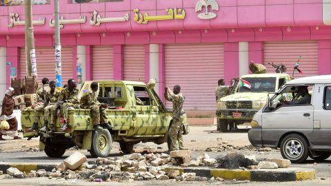 Sudanese soldiers stand guard a street in Khartoum on June 9.