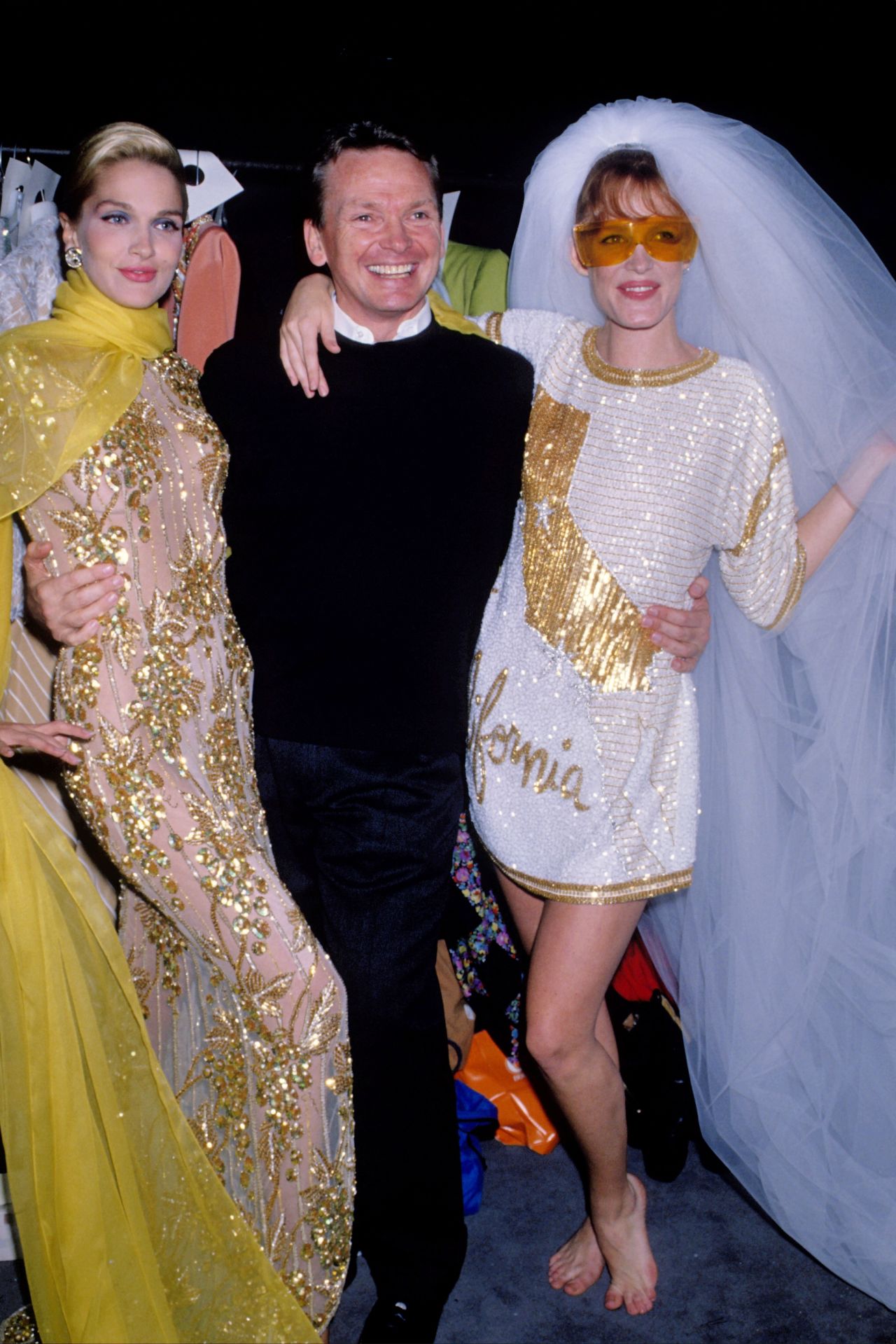 Bob Mackie poses with models during New York Fashion Week in the late 1980s.