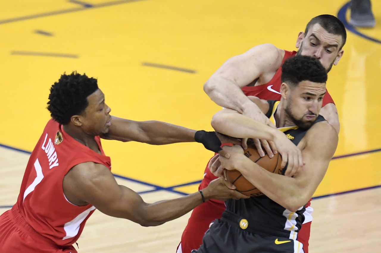 Lowry, left, and Marc Gasol double-team Thompson during Game 4 on Friday, June 7. The Raptors frustrated the high-powered Warriors en route to a 105-92 victory.
