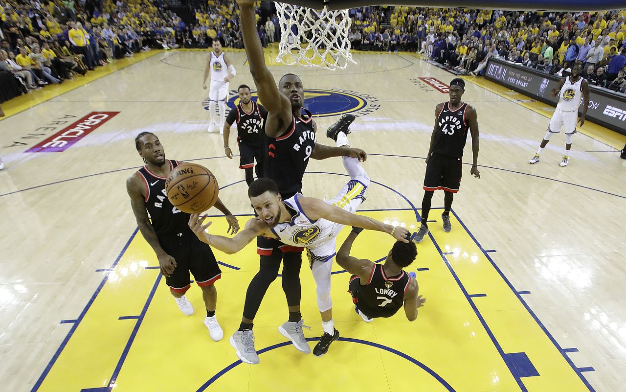 Curry is surrounded by Raptors during Game 3 on Wednesday, June 5. He scored 47 points, a playoff career-high, but it wasn't enough as the Raptors won 123-109.