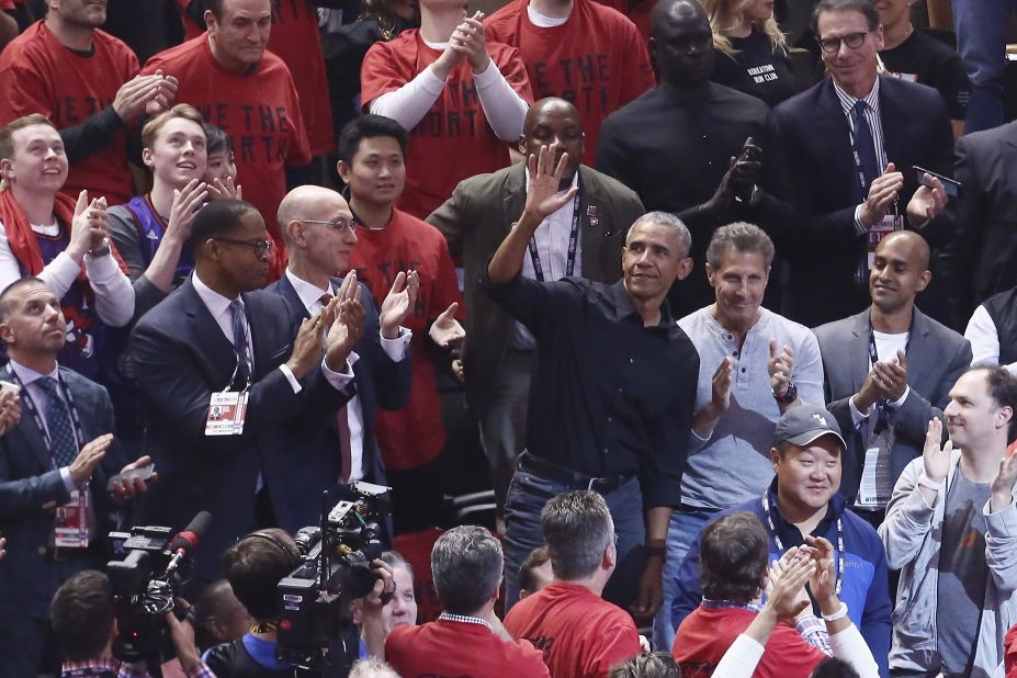 Former US President Barack Obama waves to the crowd while attending Game 2 in Toronto.