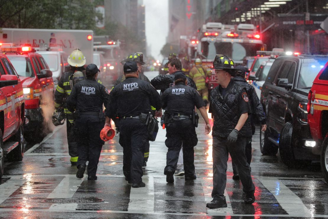 New York City police and firefighters at the scene after a helicopter crashed on the roof of a building in Manhattan on June 10, 2019.