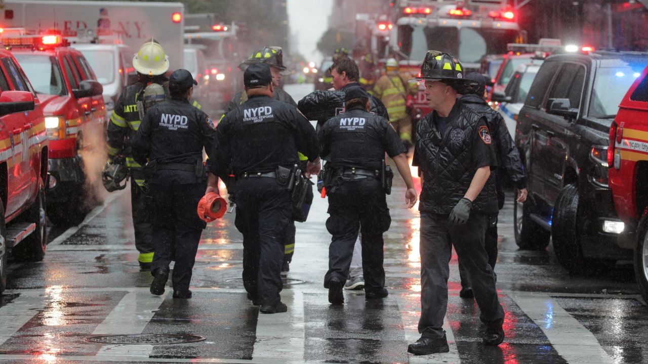 New York City police and firefighters at the scene after a helicopter crashed on the roof of a building in Manhattan on June 10, 2019.