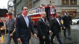 New York Gov. Andrew Cuomo, center, walks near the scene where a helicopter was reported to have crash landed on top of a building in midtown Manhattan, Monday, June 10, 2019, in New York.  (AP Photo/Mark Lennihan)