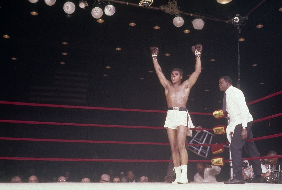 Cassius Clay, later Muhammad Ali, with his hands raised in victory over Sonny Liston on February 25, 1964 at Convention Hall in Miami, Florida.