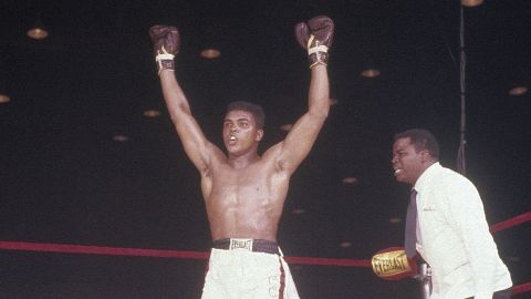 Cassius Clay, later Muhammad Ali, with his hands raised in victory over Sonny Liston on February 25, 1964 at Convention Hall in Miami, Florida.