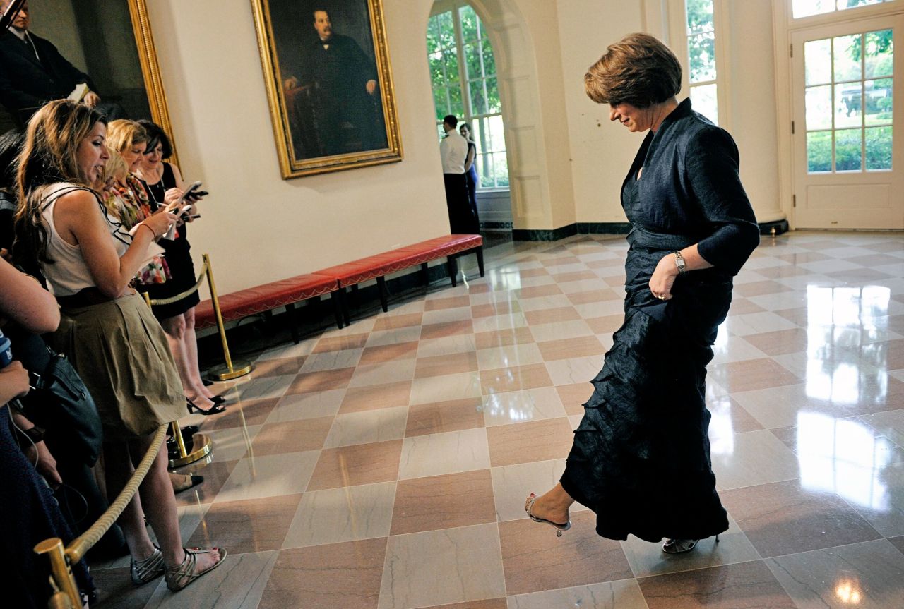 Klobuchar shows off her shoes to the press as she attends a White House dinner for German Chancellor Angela Merkel in June 2011.