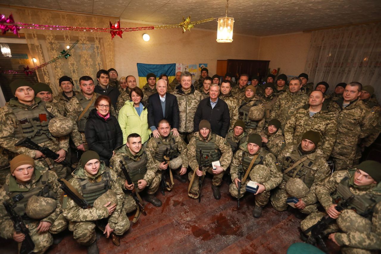 Klobuchar, in the lime-green jacket, joins two other US senators as they pose with Ukrainian service members in December 2016. To the right of Klobuchar are US Sen. John McCain, Ukrainian President Petro Poroshenko and US Sen. Lindsey Graham.