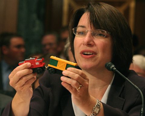 Klobuchar holds a toy train with lead paint as she testifies before a Senate subcommittee about toy safety standards in September 2007.