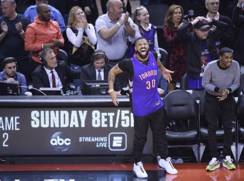 Rapper Drake, a huge Raptors fan who sits courtside and often jaws with opposing players, celebrates during Game 1. Curry's father, Dell, used to play for the Raptors, and Drake was wearing his jersey.
