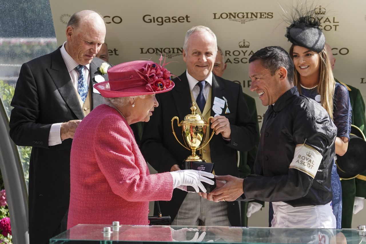 Britain's Queen Elizabeth II presents Frankie Dettori with his prize after he rode Stradivarius to win Ascot Gold Cup on day three of the royal meeting in 2018.