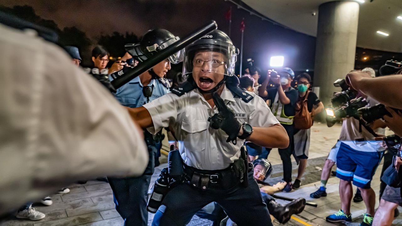 HONG KONG, HONG KONG - JUNE 10:  Police officers charge toward protesters after a rally against the extradition law proposal at the Central Government Complex on June 10, 2019 in Hong Kong. Organizers say more than a million marched on Sunday against a bill that would allow suspected criminals to be sent to mainland China for trial as tensions have escalated in recent weeks.  (Photo by Anthony Kwan/Getty Images)