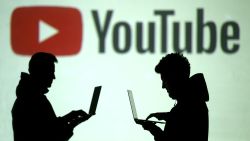 FILE PHOTO: FILE PHOTO: Silhouettes of mobile device users are seen next to a screen projection of Youtube logo in this picture illustration taken March 28, 2018.  REUTERS/Dado Ruvic/Illustration/File Photo/File Photo