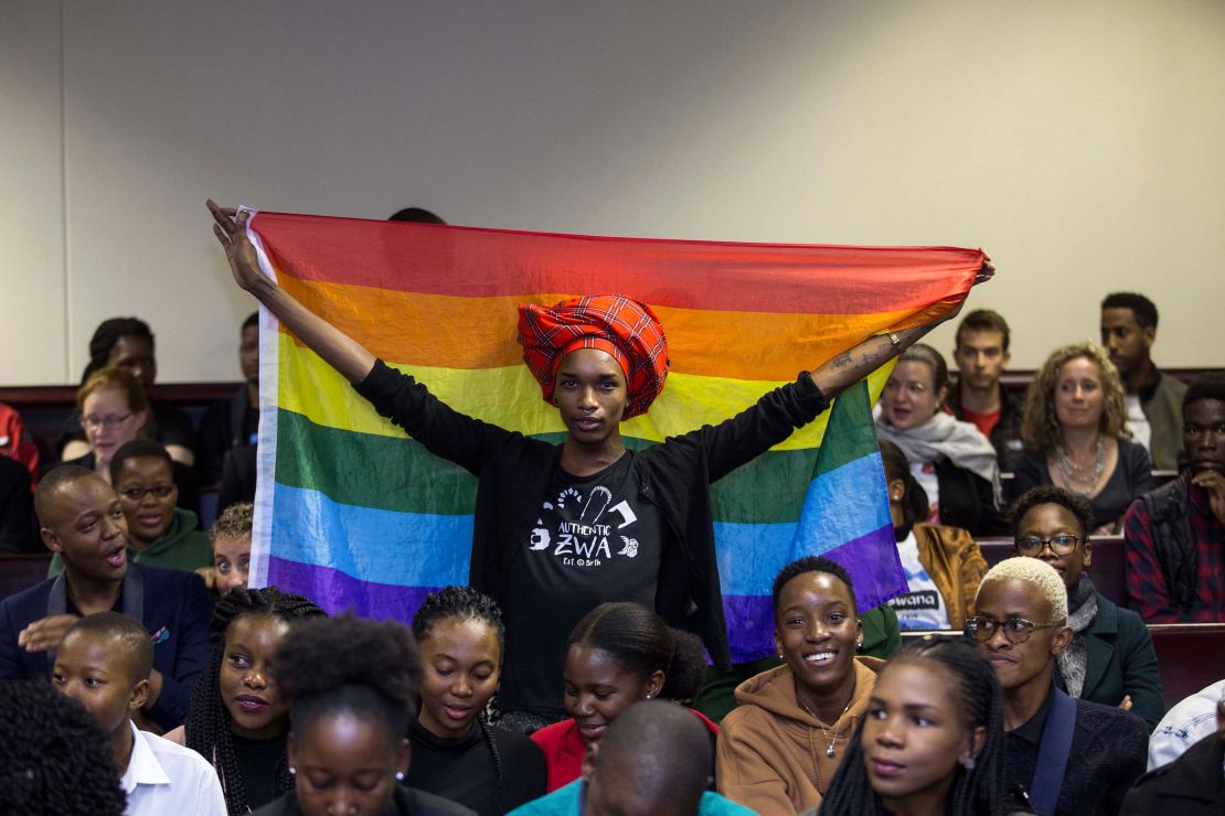 An activist holding up a rainbow flag, celebrating when high court judges in Gaborne struck down colonial-era sodomy laws.