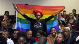 An activist holds up a rainbow flag to celebrate inside Botswana High Court in Gaborone on June 11, 2019. - Botswana's Court ruled on June 11 in favour of decriminalising homosexuality, handing down a landmark verdict greeted with joy by gay rights campaigners. (Photo by Tshekiso Tebalo / AFP)        (Photo credit should read TSHEKISO TEBALO/AFP/Getty Images)