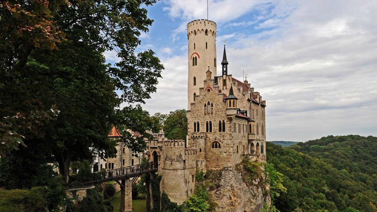 <strong>Lichtenstein Castle:</strong> Huddled in the Swabian Jura mountain range, this impressive structure sits on a steep escarpment that, depending on the season, is verdant green or bright yellow.  