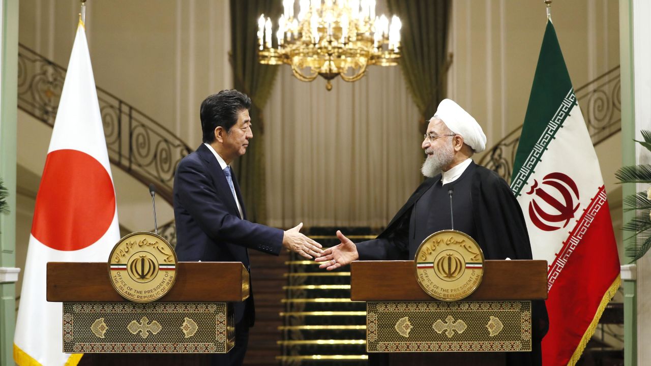 Japanese Prime Minister Shinzo Abe, left, and Iranian President Hassan Rouhani shake hands after a joint press conference in Tehran.