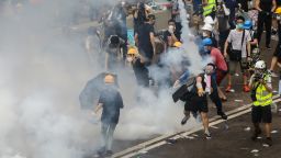A protester throws a tear gas canister fired by police during a rally against a controversial extradition law proposal outside the government headquarters in Hong Kong on June 12, 2019. - Violent clashes broke out in Hong Kong on June 12 as police tried to stop protesters storming the city's parliament, while tens of thousands of people blocked key arteries in a show of strength against government plans to allow extraditions to China. (Photo by DALE DE LA REY / AFP) 
