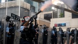 HONG KONG, HONG KONG - JUNE 12:  A police officer fire teargas during a protest on June 12, 2019 in Hong Kong China. Large crowds of protesters gathered in central Hong Kong as the city braced for another mass rally in a show of strength against the government over a divisive plan to allow extraditions to China. (Photo by Anthony Kwan/Getty Images)