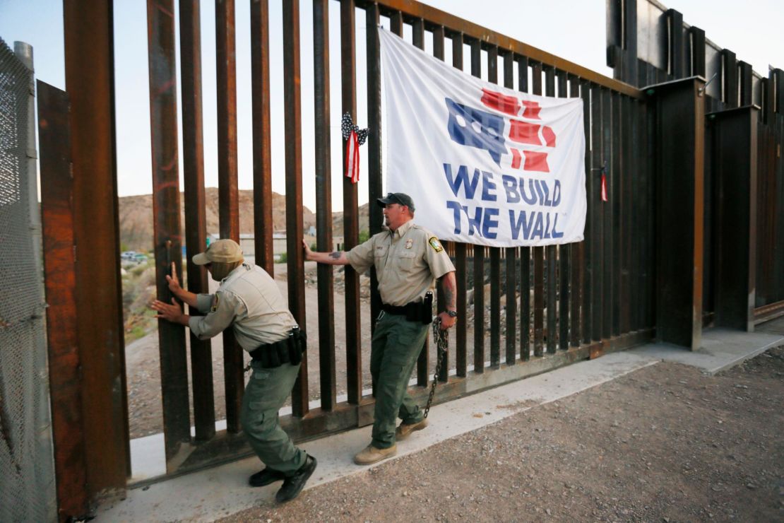 International Boundary and Water Commission personnel close a private border wall gate Tuesday night, a day after removing a private lock and padlocking the gate open.
