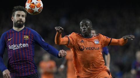 Ferland Mendy competes for the ball against Barcelona's Gerard Pique.
