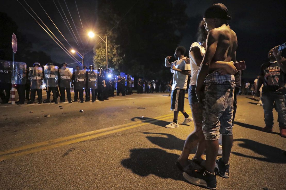 A man identified as Sonny Webber, right, the father of Brandon Webber, who was shot by US Marshals, joins a standoff as protesters take to the streets after the shooting in Memphis.