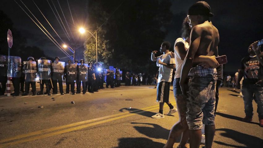A man identified as Sonny Webber, right, father of Brandon Webber who was reportedly shot by U.S. Marshals earlier in the evening, joins a standoff as protesters take to the streets of the Frayser community in anger against the shooting, Wednesday, June 12, 2019, in Memphis, Tenn. (Jim Weber/Daily Memphian via AP)