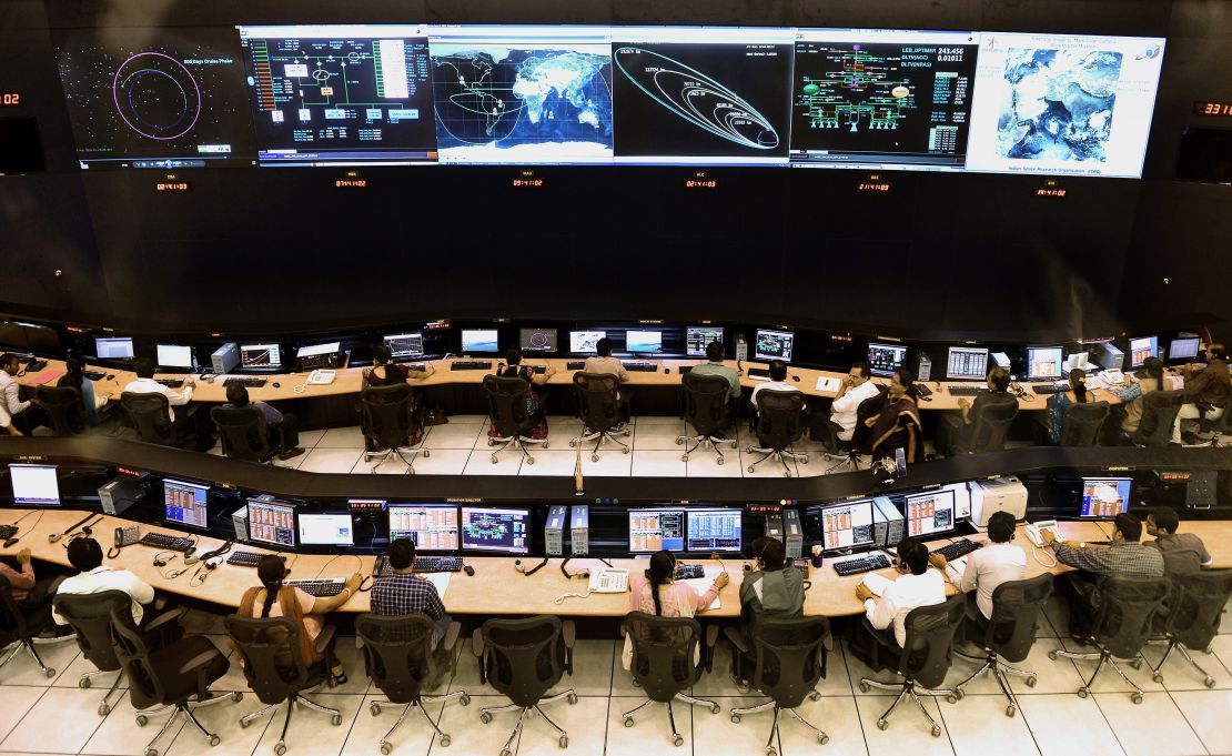 Indian scientists and engineers of Indian Space Research Organization (ISRO) monitor the Mars Orbiter Mission (MOM) at the tracking center, in Bangalore on November 27, 2013.