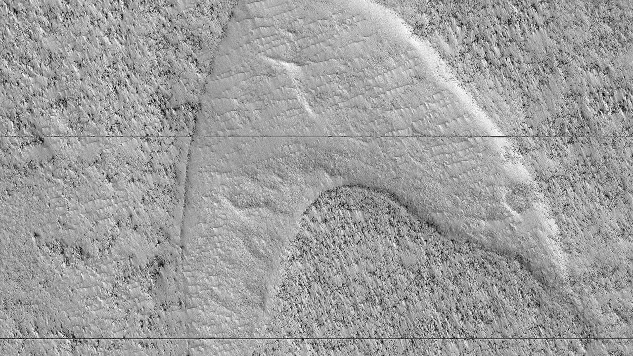 Cooled lava helped preserve a footprint of where dunes once moved across a southeastern region on Mars. But it also looks like the "Star Trek" symbol.