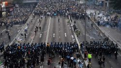 TOPSHOT - Protesters face off with police after they fired tear gas during a rally against a controversial extradition law proposal outside the government headquarters in Hong Kong on June 12, 2019. - Violent clashes broke out in Hong Kong on June 12 as police tried to stop protesters storming the city's parliament, while tens of thousands of people blocked key arteries in a show of strength against government plans to allow extraditions to China. (Photo by Anthony WALLACE / AFP)        (Photo credit should read ANTHONY WALLACE/AFP/Getty Images)