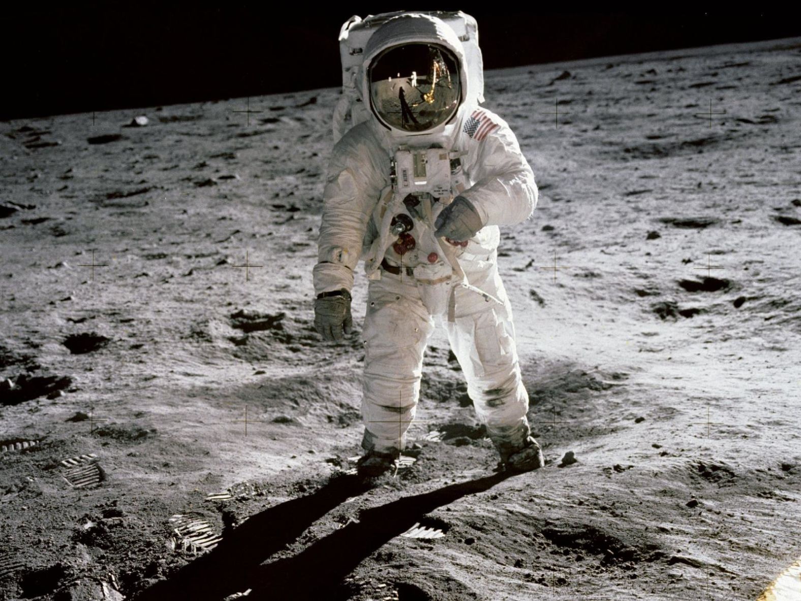 Aldrin walks on the surface of the moon. He and Armstrong spent a little over two hours collecting rock samples and data near the moon's Sea of Tranquility region. They also left behind a plaque signed by all three crew members and President Richard Nixon. The plaque reads: "Here men from the planet Earth first set foot upon the moon, July 1969 A.D. We came in peace for all mankind."