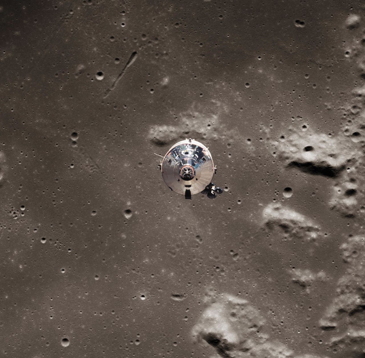 The Apollo 11 spacecraft consisted of a command module, Columbia, and a lunar module, Eagle. This photo, taken from the Eagle lunar module, shows the Columbia command module pulling away near the lunar surface.