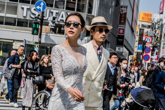 <strong>Newlywed walk:</strong> A couple struts their stuff in the busy Tokyo crosswalk.