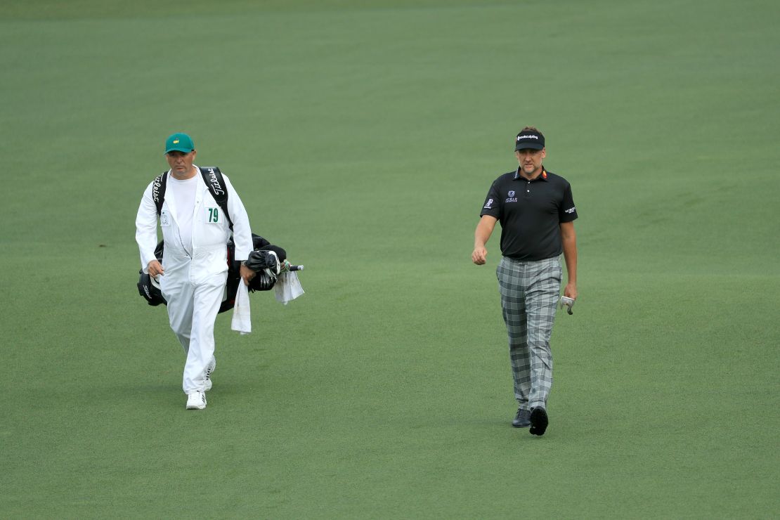 Mundy (left) wearing Augusta's traditional jumpsuit while working for Ian Poulter at the Masters. 