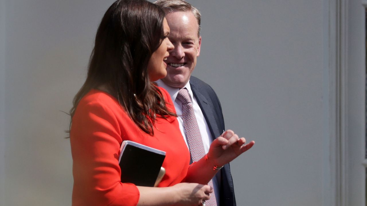 Then-White House Press Secretary Sean Spicer and Principal Deputy Press Secretary Sarah Huckabee Sanders walk out of the White House on Friday, July 21, 2017, in Washington. The White House announced that Sanders would be promoted to press secretary after Spicer announced his resignation.
