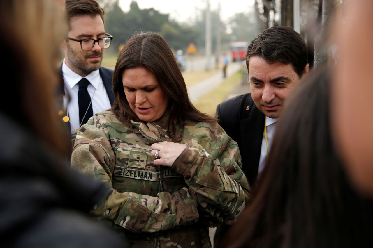 Wearing a borrowed US Army jacket,  Sanders updates reporters on President Donald Trump's failed attempt, pre-empted by weather, to visit Observation Post Ouellette along the Demilitarized Zone in the truce village of Panmunjom dividing North Korea and South Korea on November 8, 2017.