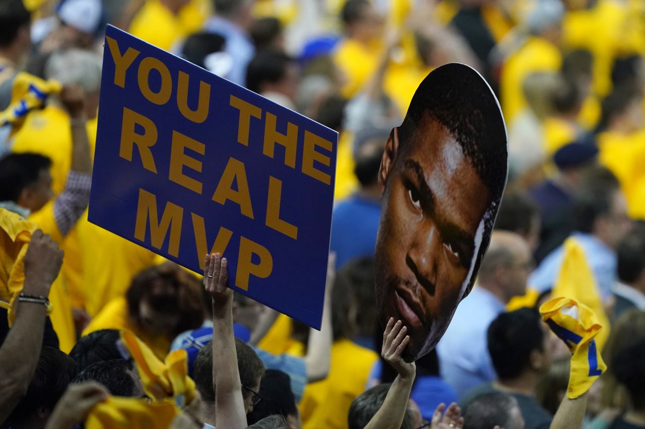 Golden State fans hold a sign for star forward Kevin Durant, who ruptured his Achilles in Game 5.