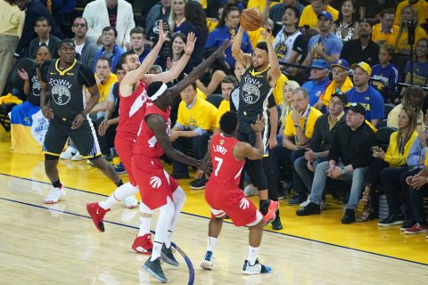 Three Raptors defend Stephen Curry in the first half of Game 6.