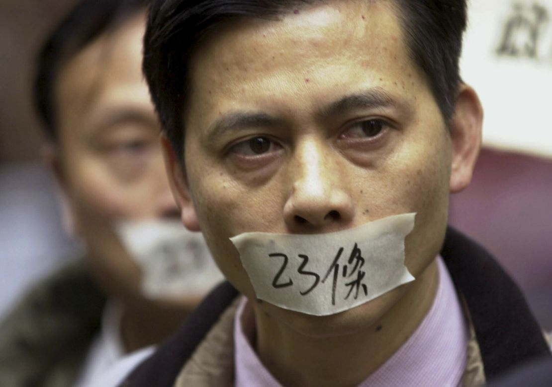 A demonstrator  put tape over his mouth with the words "Article 23" written on it in 2003.  