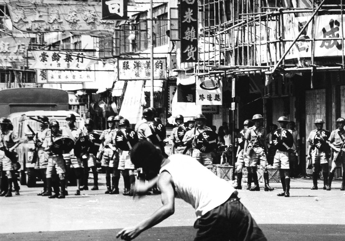 A rioter hurls rocks at riot police patrol during riots in Hong Kong, May 1967.  