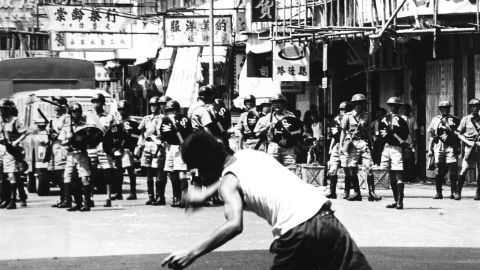 A rioter hurls rocks at riot police patrol during riots in Hong Kong, May 1967.  