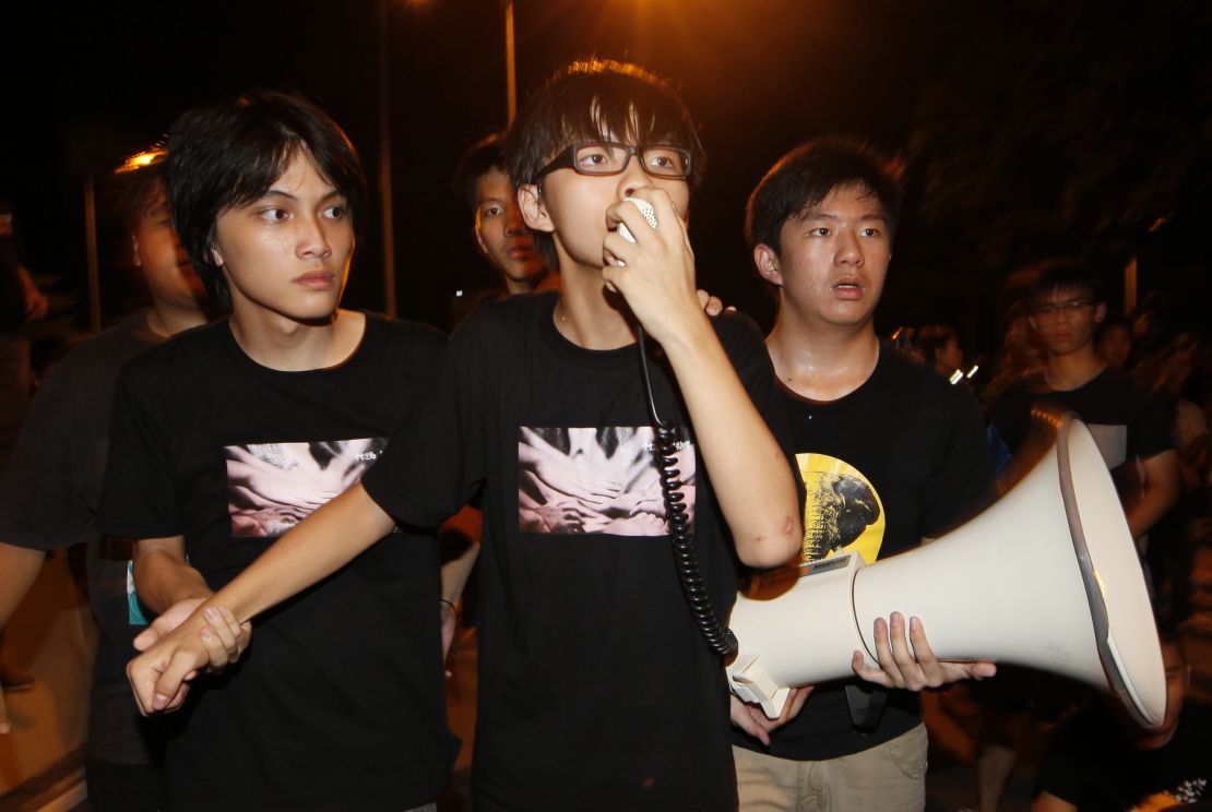 Leader of the student group "Scholarism," Joshua Wong  speaks to tens of thousands protesters outside the government headquarters in Hong Kong, in September 2012. 
