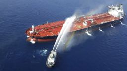An Iranian navy boat sprays water to extinguish a fire on an oil tanker in the sea of Oman, Thursday, June 13, 2019. Two oil tankers near the strategic Strait of Hormuz came under a suspected attack Thursday.